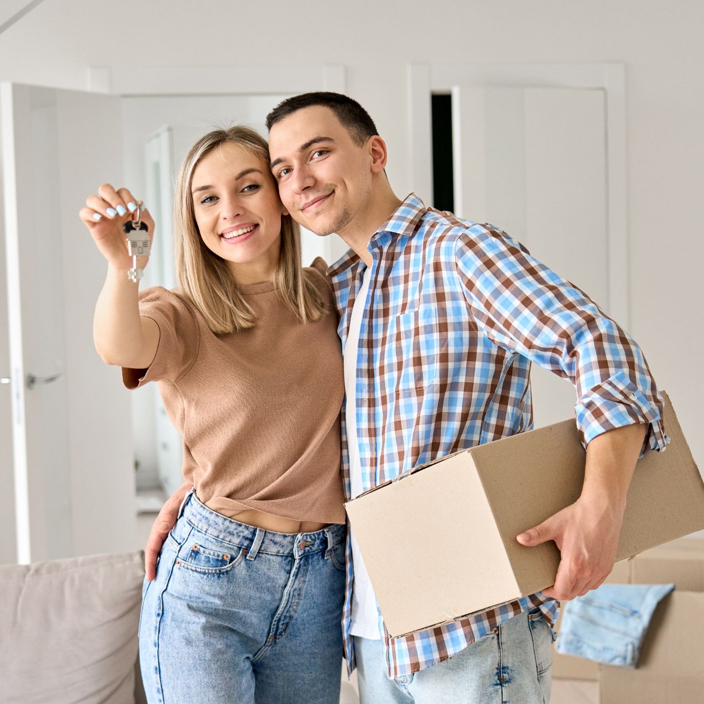 Why is buying better than renting, Couple holding keys, unboxing, moving in